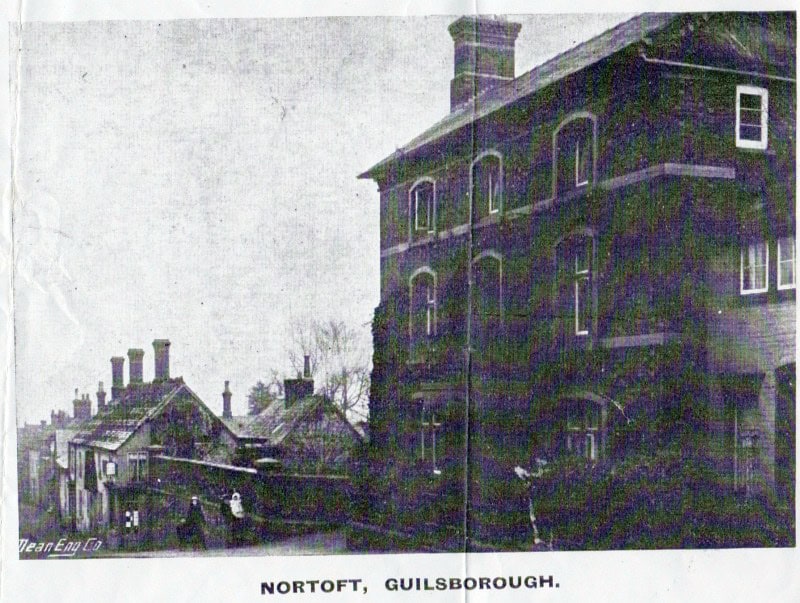Old black-and-white photo of buildings on a street labelled “NortoFt, Guilsborough”.